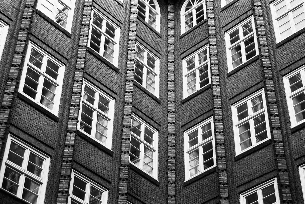 A black and white photograph of the windows of the Chilehaus in Hamburg.
